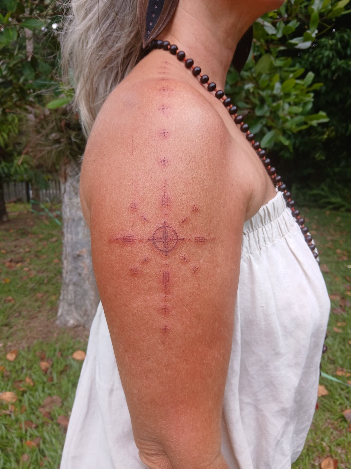 Sacred geometry compass tattoo on shoulder