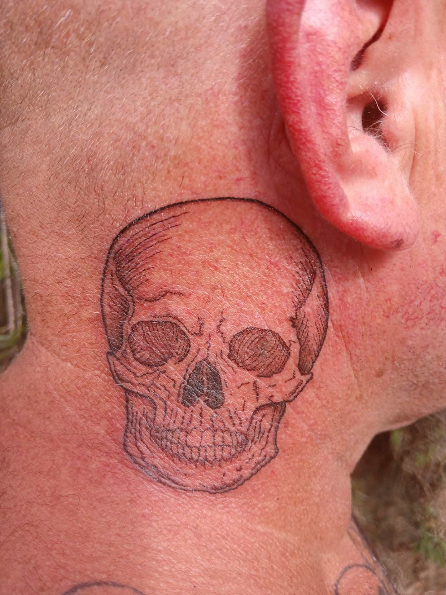 Detailed skull tattoo on neck