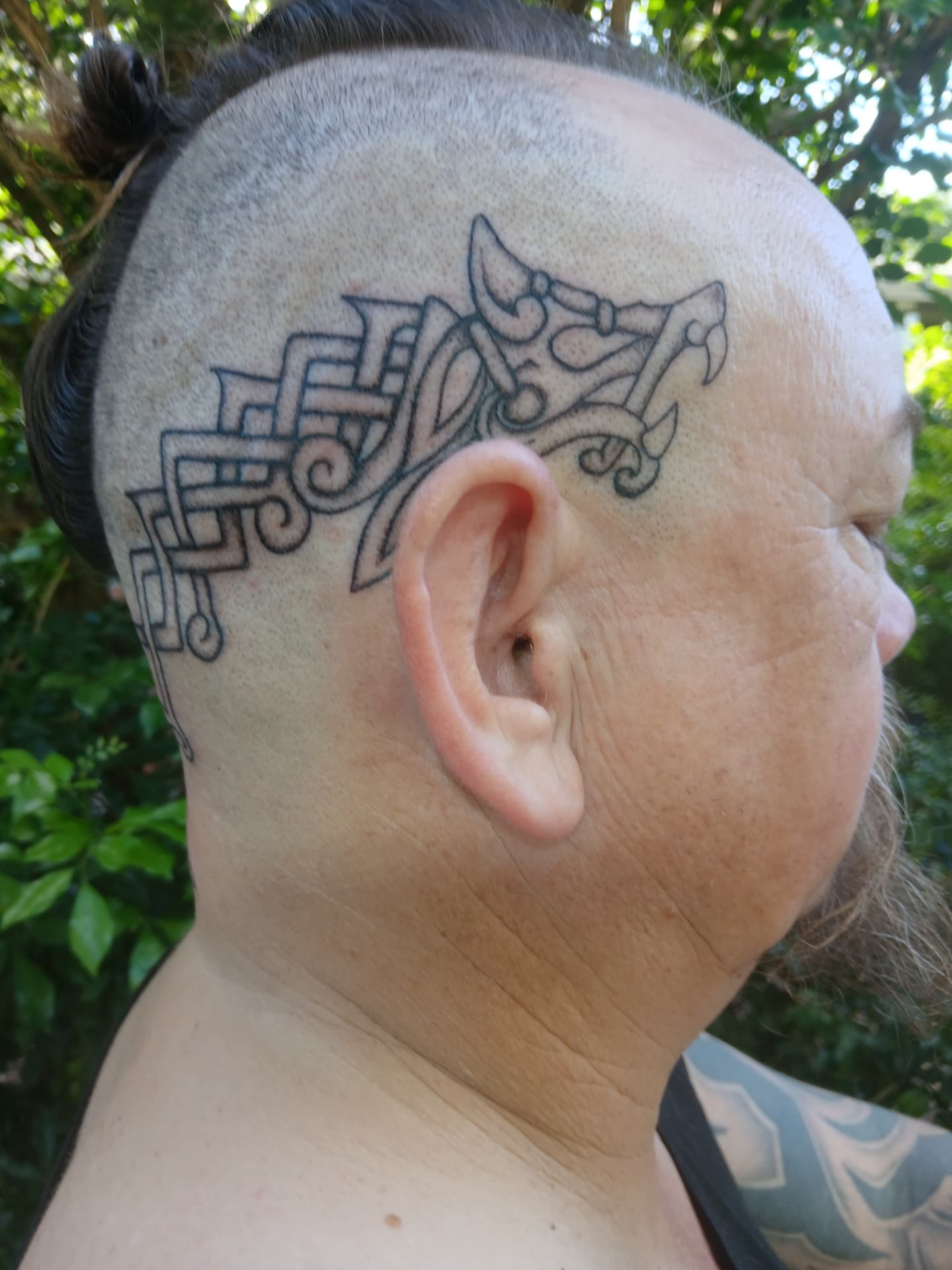 Nordic-inspired knotwork head tattoo